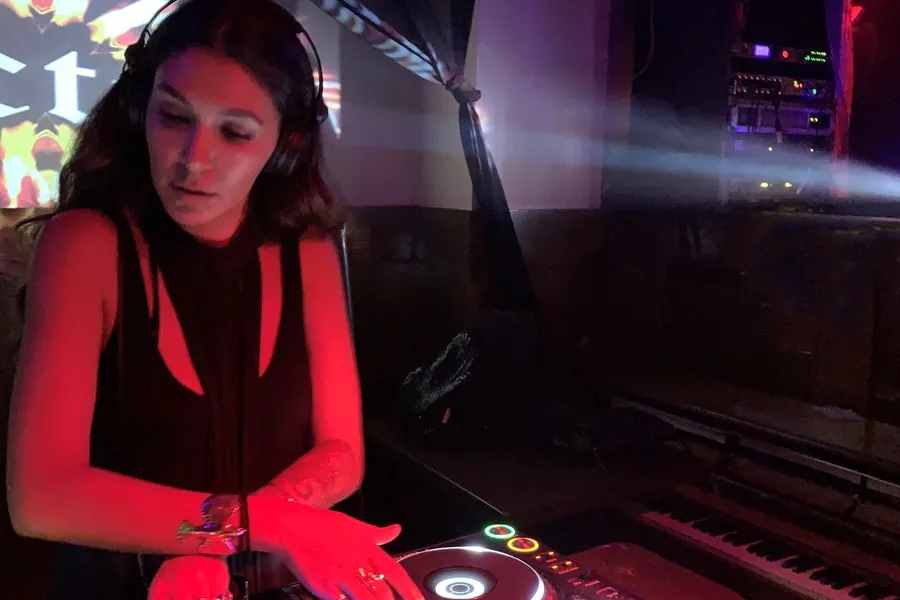 Lily Rivers mixing under a chandelier