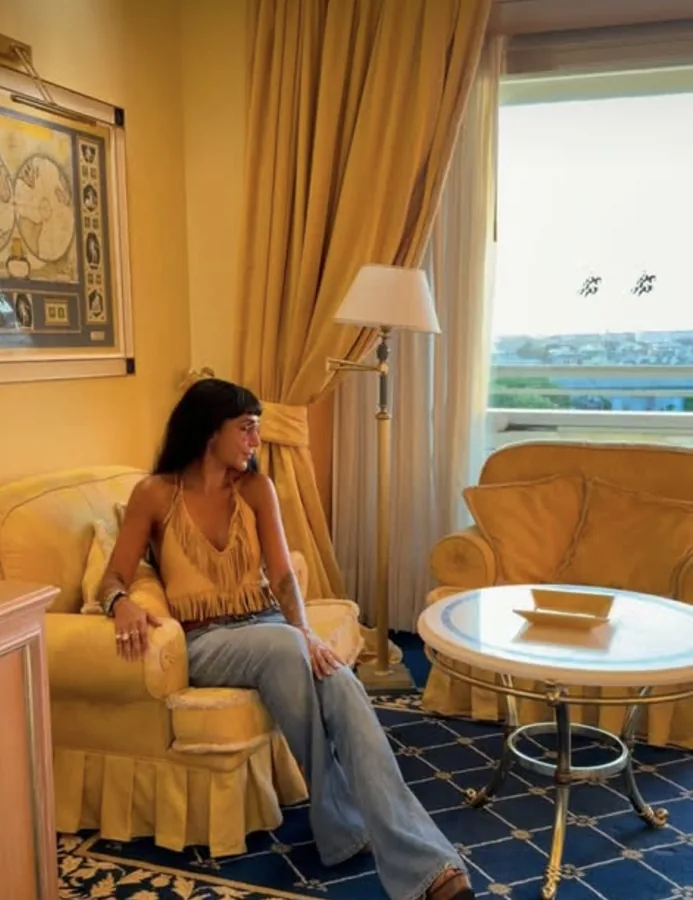 Lily Rivers relaxing in a gilded hotel suite